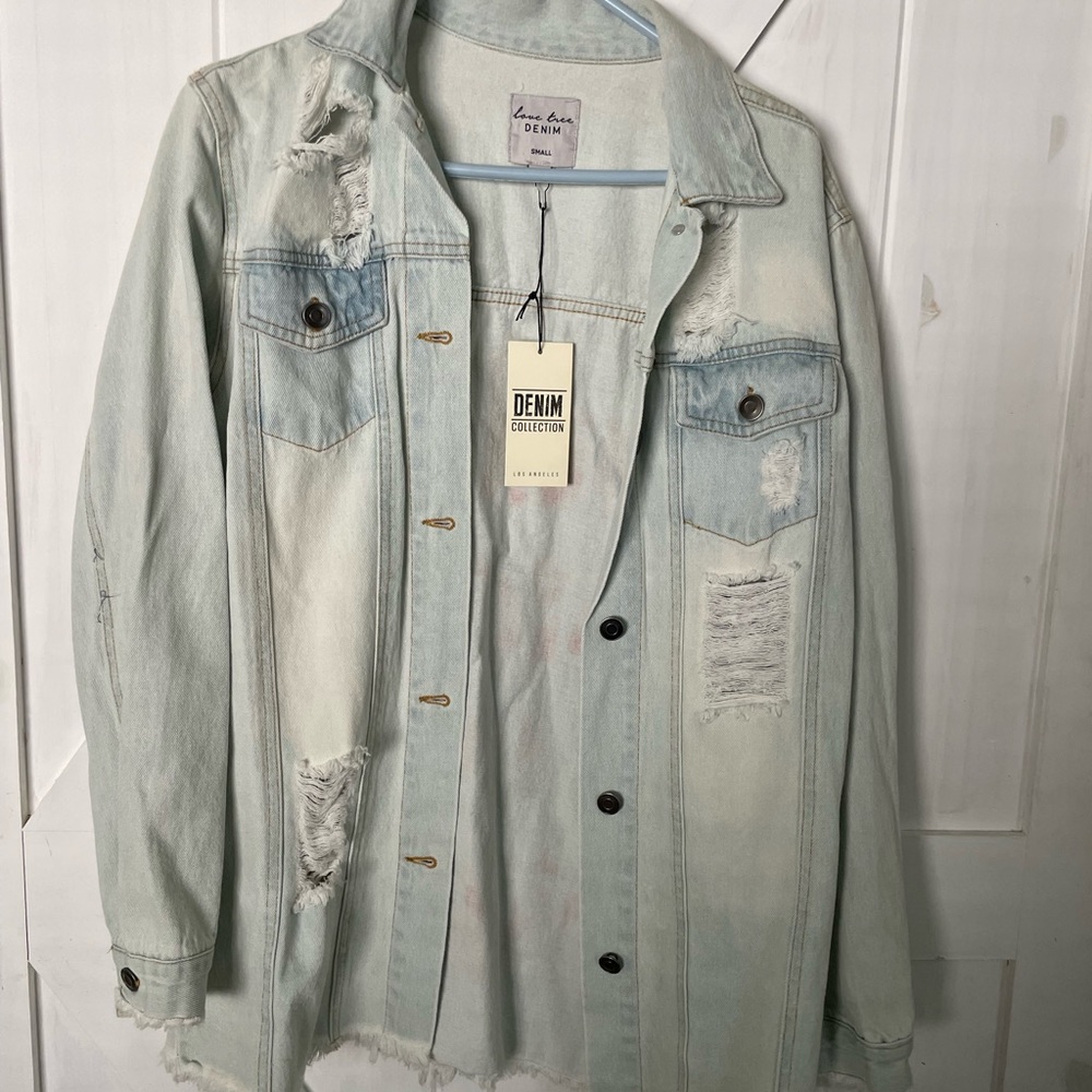 Light wash, distressed denim jacket. Ladies small. fit medium, possibly large